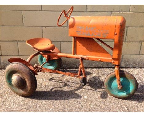 A rare Triang tinplate pedal car in the form of an Allis Chalmers three wheeler tractor, in good, original condition.