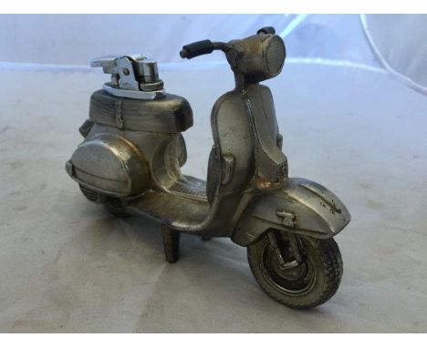 A Vespa scooter chromed metal table cigarette lighter.