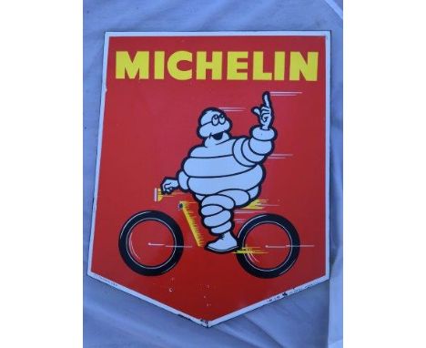 An unusual Michelin shaped enamel sign dated 1959 depicting Mr. Bibendum riding at speed on a bicycle, 15 x 17 1/2".