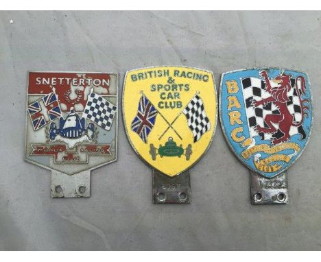 A BARC enamel car badge, L7473, a British Racing Sports Car Club badge number 2057 and a Snetterton Motor Racing Club alumini