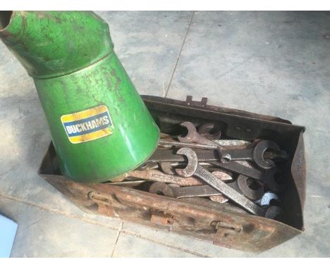 A large Duckhams gallon oil measure and a large tin trunk of spanners.