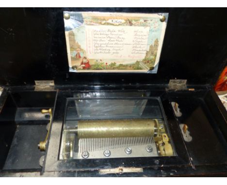 A 19th century cylinder music box playing 8 airs, in inlaid rosewood and ebonised box