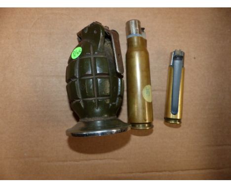 Two "Trench Art" shell case cigarette lighters, and a similar hand grenade lighter