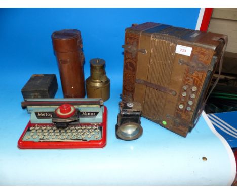 A Kuch Harmonica accordion, decorated wooden case; a Mettoy tinplate toy typewriter;a cycle lamp