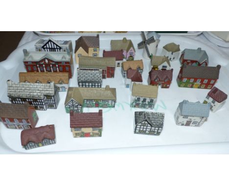 A collection of 25 Wade miniature village buildings; a selection of doll's house furniture