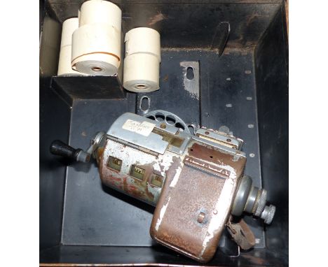 A vintage bus conductor's ticket issue machine, with rolls, in metal box