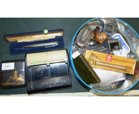 A selection of smoking related collectables including lighter; cigar cutters; etc.