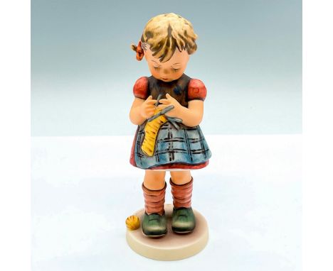 Hand painted figure of a young girl knitting. Goebel Hummel backstamp. Issued: c. 1979-1990Dimensions: 2.75"L x 2.5"W x 6.5"H