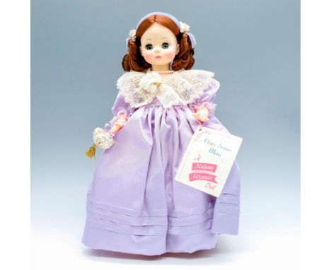 Original replica of Mimi dressed in a purple dress with white lace trimming and velvet headband. wrap. This item has its orig