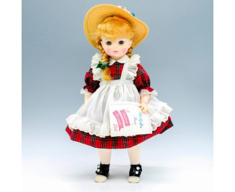 Original blonde McGuffey Ana dressed in a red plaid frock, white apron, knit tights and garden hat. This item has its origina