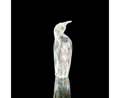 A clear crystal figure of a penguin standing with his wings at his sides. Swarovski backstamp. This item has its original box