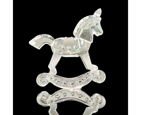 Sparkling faceted and molded crystal figurine modeled as a tiny rocking horse with blue eyes and gem-like texture details. Sw