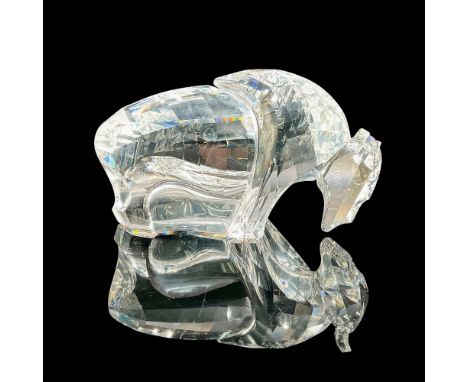 Made of clear crystal with faceted head and body designed to capture and refract light in various directions that intensify a