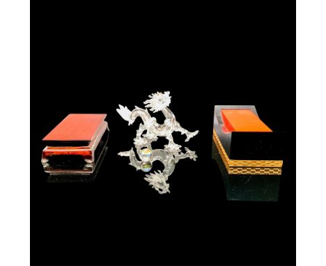 A clear crystal figurine of a dragon standing on four legs with topaz-colored crystals used for the eyes. Swarovski backstamp