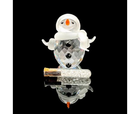 Adorable faceted crystal figurine modeled as a smiling snowman with black gem buttons, orange carrot nose, and frosted scarf.