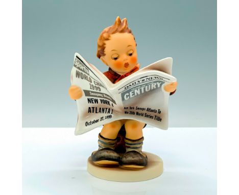 A figure of a young boy with an orange jacket and black shorts sitting on a wooden stool while reading a newspaper. Goebel Hu