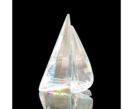 A clear crystal figure of a sailboat with two sails. Swarovski backstamp. This item has its original box. Dimensions of the o