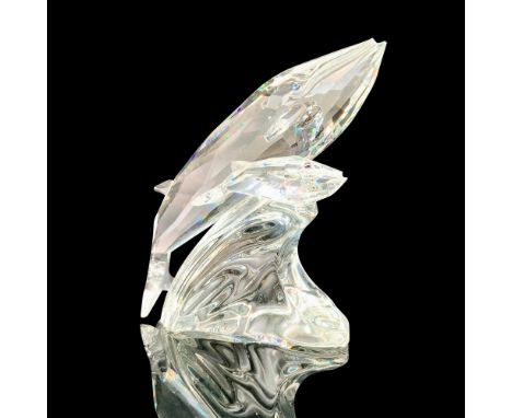 A clear crystal figurine of a mother whale and her young swimming side by side. Blue crystals used for the eyes. Swarovski ba