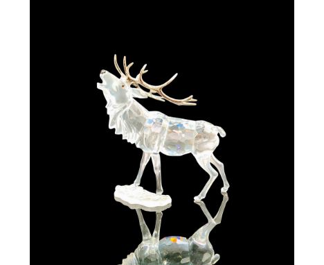 A clear crystal figure of a deer with antlers made of rhodium with black crystals used for the eyes and snout. Swarovski back