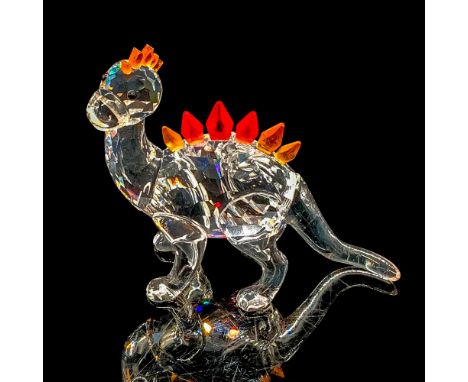 Crystal dinosaur with clear body and black crystal eyes. Orange crystal scales located on the top of the head with red, yello