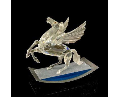 Clear body, face and wings with frosted mane and tail. Yellowish inset eyes with black pupils. Swarovski backstamp. Figurine 