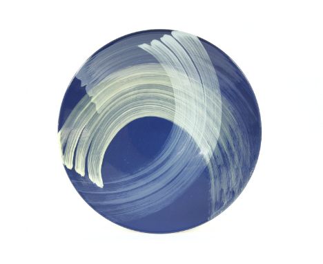 A Poole Studio charger, on a blue ground with brushstrokes, monogrammed, 41cm diameter