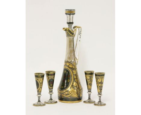 An enamelled and gilt decanter, stopper and four glasses, c.1920, each painted with a floral roundel reserved on a gilt leaf 