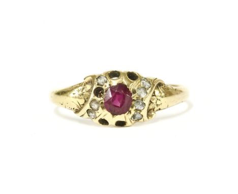 A gold oval cut ruby and rose cut diamond cluster ring, with engraved floral shoulders (five diamonds deficient)2.04g