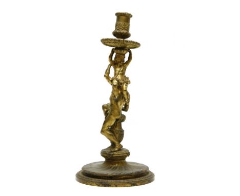 A 19th century French ormolu candlestick, in the form of two children climbing on a circular base (hole to drip pan)