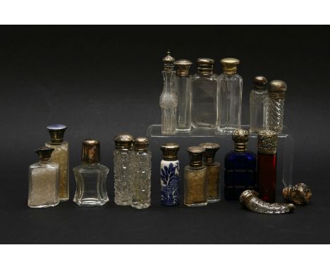 Seventeen glass and one ceramic scent bottles, nine with silver and eight with silver plated mounts