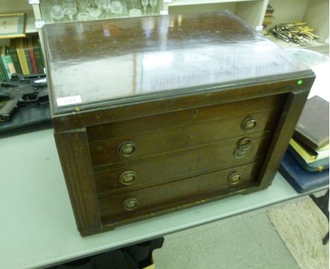 An early 20thC mahogany canteen, having a hinged lid, enclosing four fabric lined fitted drawers with lockable fluted flanks,