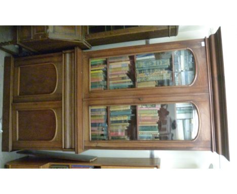 A late Victorian mahogany cabinet bookcase, having a moulded cornice and a pair of glazed doors, enclosing three height adjus