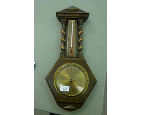 A 1930s oak barometer, having barleytwist columns and a gilt finished Arabic dial  18''h         OS2