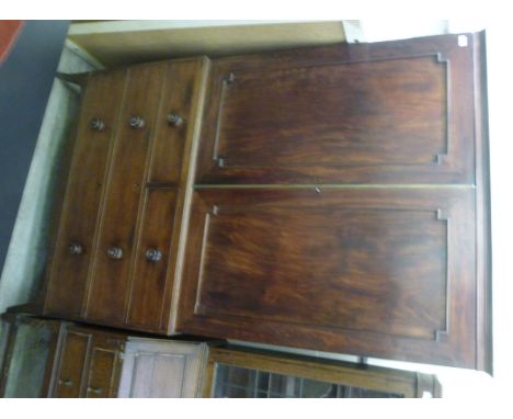 An early 19thC mahogany linen press, having a moulded cornice, over twin recessed panelled doors, enclosing four slides, abov