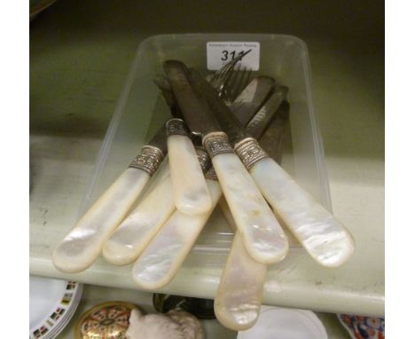 A set of six silver plated dessert knives and forks, on mother-of-pearl handles        OS3