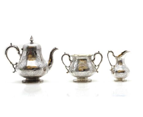 A Victorian three piece silver tea service by Martin, Hall &amp; Co., Sheffield 1864, the teapot with ivory insulators, each 