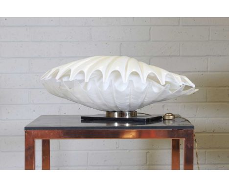 A clamshell lamp, 1970s, designed by Roger Rougier, with a hinged white Perspex top, over a mottled base with an inner shade,