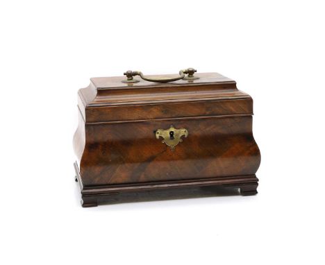 A George III mahogany tea caddy  of bombe form, with a brass swan neck handle and escutcheon, the interior fitted with three 