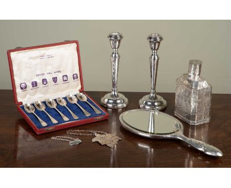 A pair of silver candlesticks 19cm high; a foreign silver flask with embossed decoration of figures, 14cm high; a set of six 
