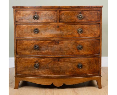 A 19th century mahogany bow fronted chest of two short and three long drawers with octagonal plated ring handles, oak drawer 