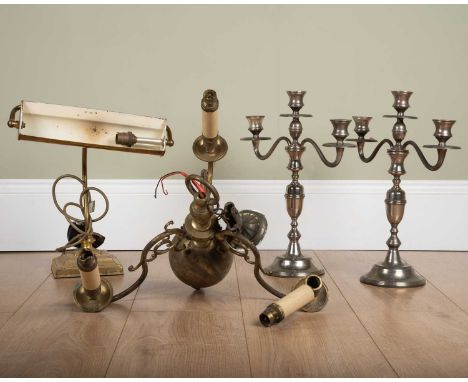 A pair of white metal three-branch candelabra on turned bases, 39cm high, together with; a brass Flemish-style three-branch c