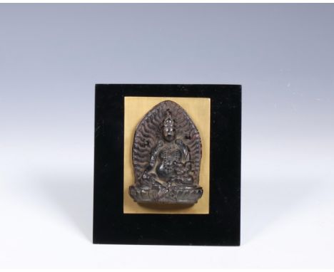 Nepal, small bronze plaque of a bodhisattva, 19th century, seated in lalitasana on a lotus base, mandorla behind him, mounted