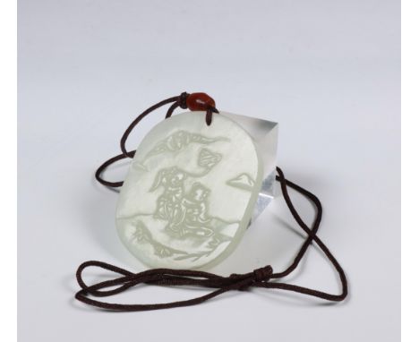 China, celadon jade pendant, carved in relief with two boys and a bat, the reverse with a seal mark (some nicks) h. 5,4 cm [1