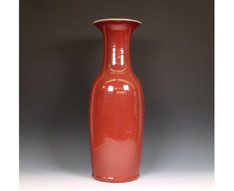 China, copper-red-glazed vase, 19th century, the tall slender vase covered with a streaked strawberry-red glaze thinning to m