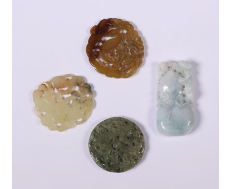 China, four various jade and jadeite pendants, 20th century, three of circular shape and variously carved with flowers and bi