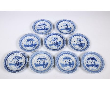 China, set of nine blue and white porcelain saucers, Kangxi period (1662-1722), each with canted rim and decorated with two l