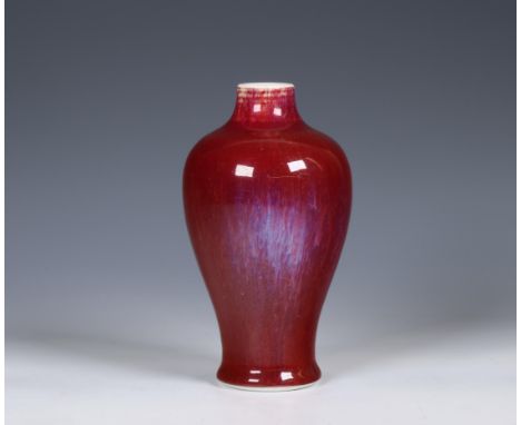 China, flambé-glazed porcelain vase, 19th/ 20th century, the baluster sides covered with a copper-red glaze streaked with pur