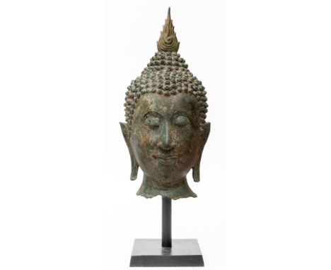 Thailand, bronze head of Buddha, 20th century, wearing serene expression, elongated earlobes and curly hair surmounted by a f