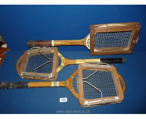Three wooden tennis racquets with presses: Wisden, Slazenger Challenge no.2 and Dunlop Green Flash.