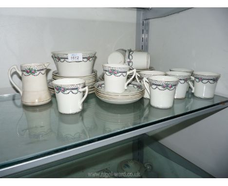 A pretty vintage Tea service black garlands and edging with Peonies, eleven each cups and saucers, twelve tea plates, sandwic